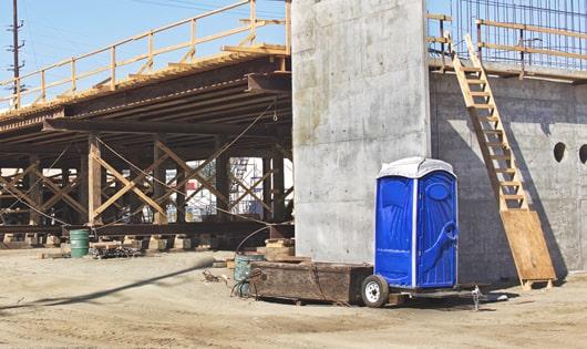 portable restrooms lined up neatly, ready to serve work site workers